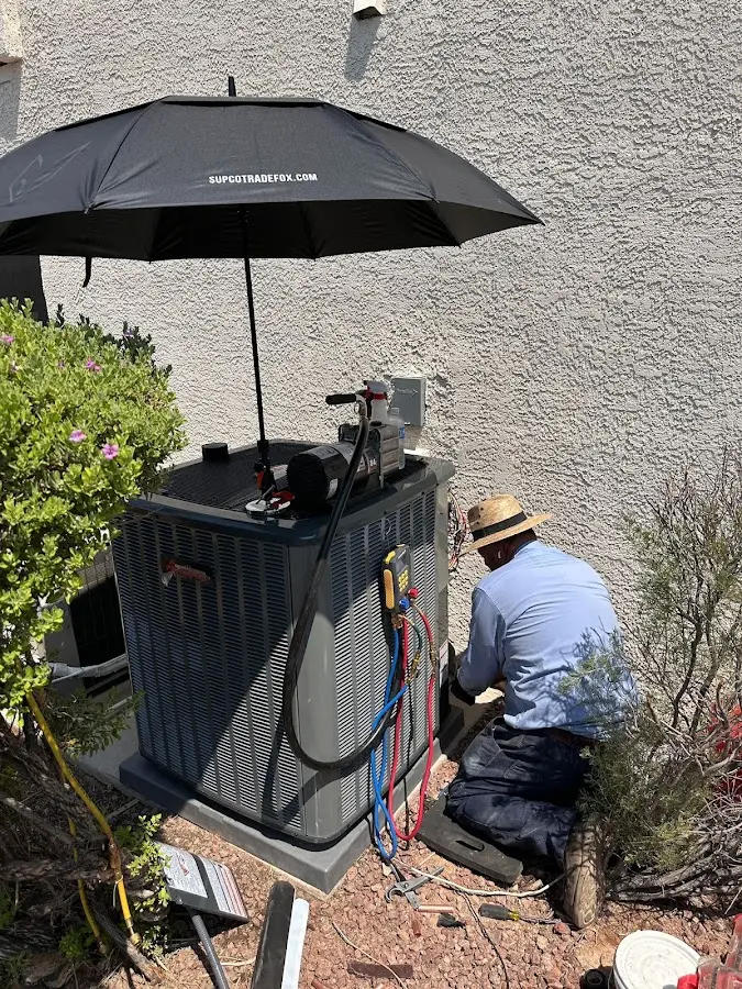 HVAC technician performing outdoor AC maintenance in Alondra Park